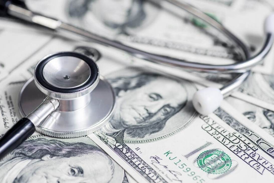 A stethoscope and a stethoscope on top of money
AI-generated content may be incorrect.